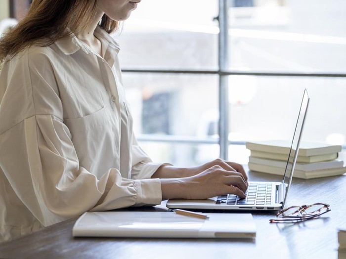 Ilustrasi wanita bekerja The hand of a young woman working at remote work
