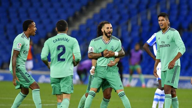 Karim Benzema Real Madrid's Karim Benzema celebrates his goal during the Spanish La Liga soccer match between Real Sociedad and Real Madrid at Anoeta stadium, San Sebastian, Spain, Sunday, June 21, 2020. (AP Photo/Alvaro Barrientos)