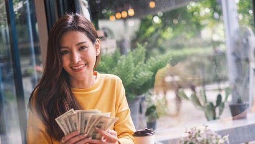 happy Asian woman hand holding smart phone and banknotes ,make money online concept