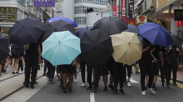Protesters set up defense shield using umbrellas on a road during against the new national security law march of Hong Kong's handover to China from Britain in Hong Kong, Wednesday, July. 1, 2020. Hong Kong marked the 23rd anniversary of its handover to China in 1997, and just one day after China enacted a national security law that cracks down on protests in the territory. (AP Photo/Vincent Yu)