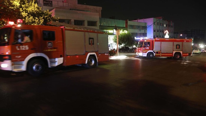 A man whose relative is on staff at Sina Athar Clinic weeps after its explosion, outside the clinic in Tehran, Iran, early Wednesday, July 1, 2020. Iranian state TV says an explosion from a gas leak in a medical clinic in northern Tehran has killed multiple people. (AP Photo/Vahid Salemi)