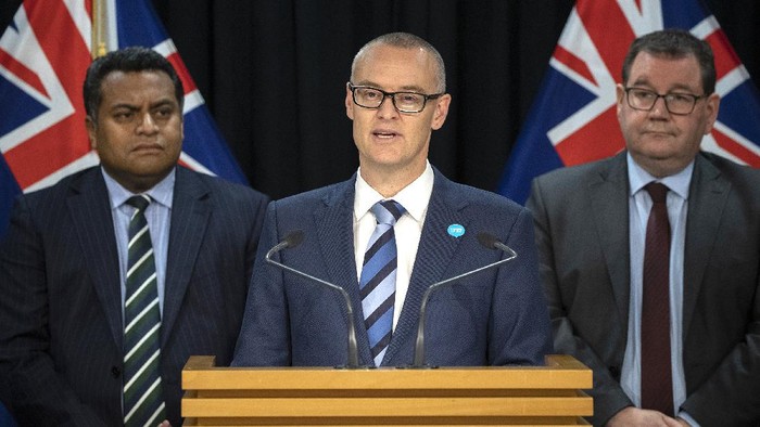 New Zealand Health Minister David Clark, center, flanked by Cabinet colleagues Grant Robertson, right, and Kris Faafoi addresses a press conference where he announced his resignation at parliament in Wellington, New Zealand Thursday, July 2, 2020. Clark resigned Thursday following a series of personal blunders during the coronavirus pandemic. (Mark Mitchell/New Zealand Herald via AP)