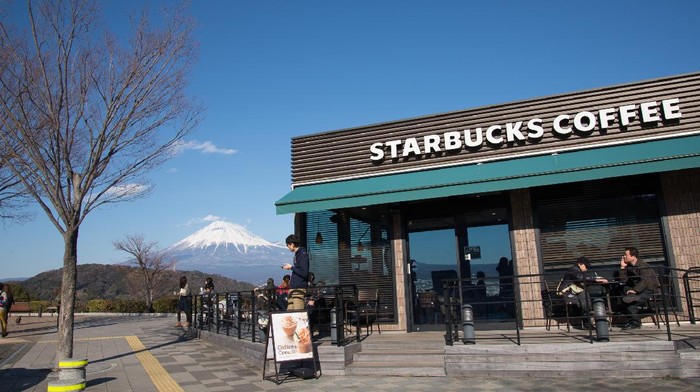 Shizuoka, Japan - February 14, 2015: Starbucks Coffee and Mount Fuji near Fuji River Service area. It is considered one of the most beautiful Starbucks branch in Japan