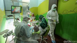 Sejumlah protokol kesehatan diterapkan di klinik khusus anak-anak di Jakarta. Salah satunya para dokter disana kenakan alat pelindung diri saat bertugas.