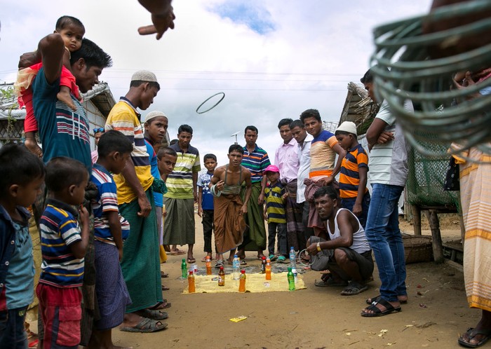 COX'S BAZAR, BANGLADESH -: Rohingya Muslims celebrate at a fair during Eid al-Adha in a refugee camp August 12, 2019 in Cox's Bazar, Bangladesh.  Eid al-Adha, or the Festival of Sacrifice, marks the end of the Hajj pilgrimage to Mecca and in commemoration of Prophet Abraham's readiness to sacrifice his son to show obedience to God. Muslims slaughter a sacrificial animal and split the meat into three parts, one for the family, one for friends and relatives, and one for the poor and needy. (Photo by Allison Joyce/Getty Images)