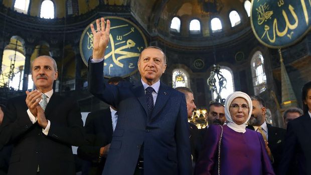People visit the Byzantine-era Hagia Sophia, one of Istanbul's main tourist attractions in the historic Sultanahmet district of Istanbul on Thursday, June 25, 2020. The 6th-century building is now at the center of a heated debate between conservative groups who want it to be reconverted into a mosque and those who believe the World Heritage site should remain a museum. (AP Photo/Emrah Gurel)