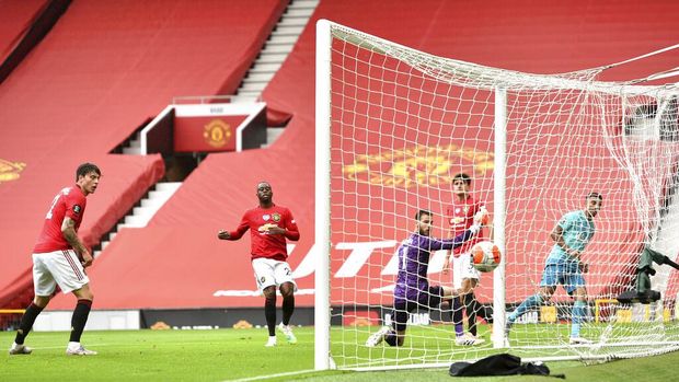 Bournemouth's Junior Stanislas, right, watches the net after scoring a goal during the English Premier League soccer match between Manchester United and Bournemouth at Old Trafford stadium in Manchester, England, Saturday, July 4, 2020. (Peter Powell/Pool via AP)