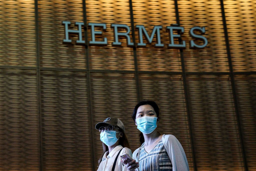 WUHAN, CHINA - JUNE 30: (CHINA OUT) Residents wear face masks while passing by a Hermes store on June 30, 2020 in Wuhan, China. Since June 13, 2020 the response level of public health emergencies in Hubei Province has been reduced to level 3. Wuhan's health commission said that the city had no asymptomatic cases as of June 15, and there are no more close contacts under medical observation.(Photo by Getty Images)