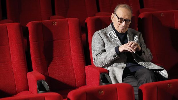 FILE - In this Dec. 6, 2013 file photo, Italian composer Ennio Morricone poses during a photo call to promote his German 2014 concerts, in Berlin, Germany. Morricone, who created the coyote-howl theme for the iconic Spaghetti Western “The Good, the Bad and the Ugly” and the soundtracks such classic Hollywood gangster movies as “The Untouchables,” died Monday, July 6, 2020 in a Rome hospital at the age of 91. (AP Photo/Michael Sohn, file)