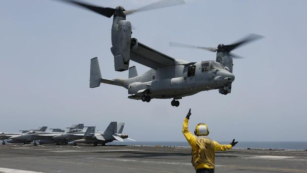In this Friday, May 17, 2019, photo released by the U.S. Navy, Aviation Boatswain's Mate 2nd Class Nicholas Hawkins, from Houston, Texas, signals an MV-22 Osprey to land on the flight deck of the Nimitz-class aircraft carrier USS Abraham Lincoln in the Arabian Sea. Commercial airliners flying over the Persian Gulf risk being targeted by 