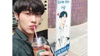 Berpose lucu di depan food truck kiriman penggemarnya. Begini Woo Do Hwan saat menikmati segelas es kopi Americano yang nikmat. Foto: Instagram @wdhwan