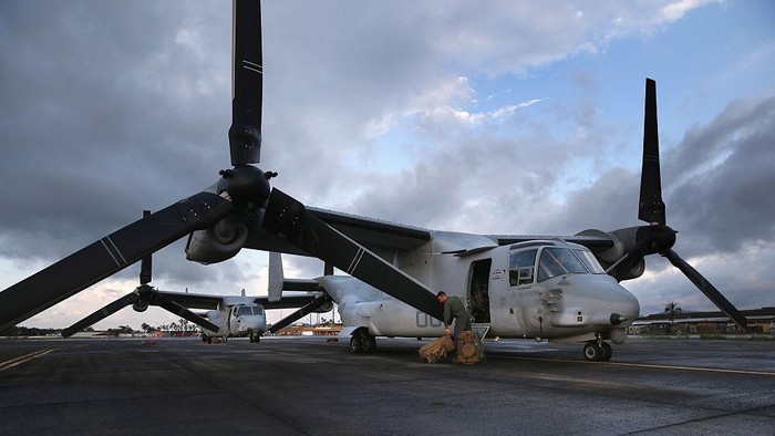 MONROVIA, LIBERIA - OCTOBER 09:  A U.S. Marine deplanes after arriving on an MV-22 Osprey to take part in Operation United Assistance on October 9, 2014 in Monrovia, Liberia. Some 90 Marines arrived on KC-130 transport planes and the Ospreys to support the American effort to contain the Ebola epidemic. The four Ospreys, which can land vertically like helicopters, will transport U.S. troops and supplies as they build 17 Ebola treatment centers around Liberia.  U.S. President Barack Obama has committed up to 4,000 troops in West Africa to combat the disease.  (Photo by John Moore/Getty Images)