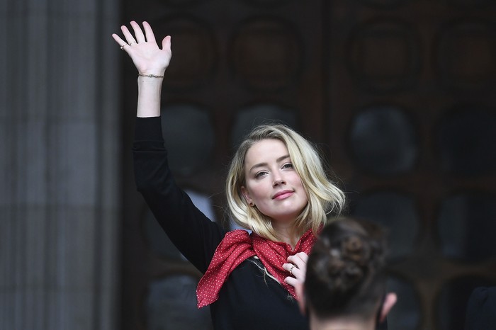 Actress Amber Heard, center, arrives at the High Court in London, Tuesday, July 7, 2020. Johnny Depp has a starring role in a real-life courtroom drama in London, where he is suing a tabloid newspaper for libel over an article that branded him a 