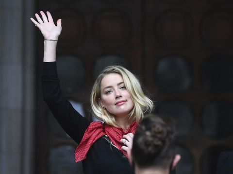Actress Amber Heard, center, arrives at the High Court in London, Tuesday, July 7, 2020. Johnny Depp has a starring role in a real-life courtroom drama in London, where he is suing a tabloid newspaper for libel over an article that branded him a 