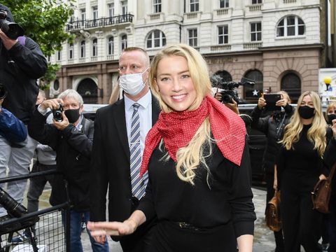 Actress Amber Heard, center, arrives at the High Court in London, Tuesday, July 7, 2020. Johnny Depp has a starring role in a real-life courtroom drama in London, where he is suing a tabloid newspaper for libel over an article that branded him a 