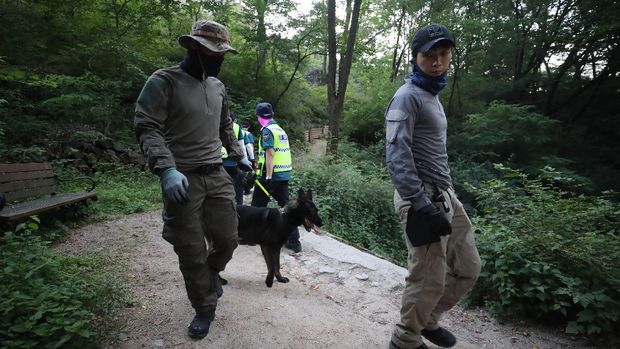 Police officers search for missing Seoul Mayor Park Won-soon in Seoul, South Korea, Thursday, July 9, 2020. Police say Park has been reported missing and search operations are underway. (Kim Ju-sung/Yonhap via AP)