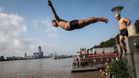 Meluapnya sungai Yangtze dimanfaatkan warga untuk bermain air dan berenang.  