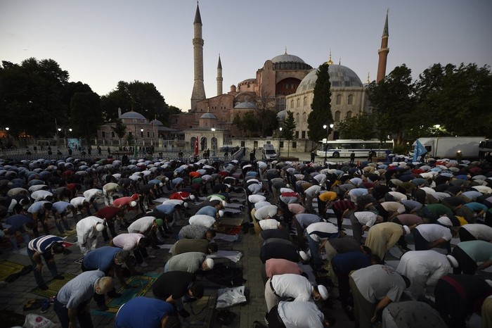 Hagia Sophia Muslims offer their evening prayers outside the Byzantine-era Hagia Sophia, one of Istanbul's main tourist attractions in the historic Sultanahmet district of Istanbul, following Turkey's Council of State's decision, Friday, July 10, 2020. Turkey's highest administrative court issued a ruling Friday that paves the way for the government to convert Hagia Sophia - a former cathedral-turned-mosque that now serves as a museum - back into a Muslim house of worship. The Council of State threw its weight behind a petition brought by a religious group and annulled a 1934 cabinet decision that changed the 6th century building into a museum.