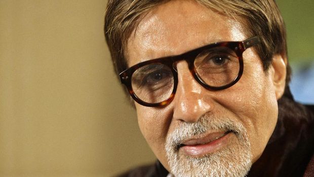 Civic workers sanitize the entrance of Bollywood superstar Amitabh Bachchan's residence after Bachchan and his son tested positive for the coronavirus and were hospitalized in Mumbai, India, Sunday, July 12, 2020. (AP Photo/Rafiq Maqbool)