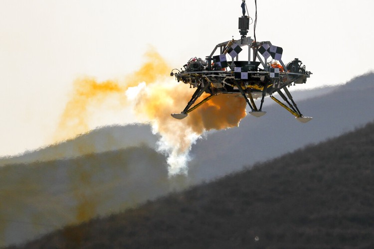 FILE - In this Thursday, Nov. 14, 2019 file photo, a Mars lander is lifted during a test for its hovering, obstacle avoidance and deceleration capabilities at a facility at Huailai in Chinas Hebei province. The site outside Beijing simulated conditions on the red planet, where the pull of gravity is about one-third that of Earth. China will launch their Mars rover and an orbiter sometime around July 23, 2020, in a mission named Tianwen, or Questions for Heaven. (AP Photo/Andy Wong)