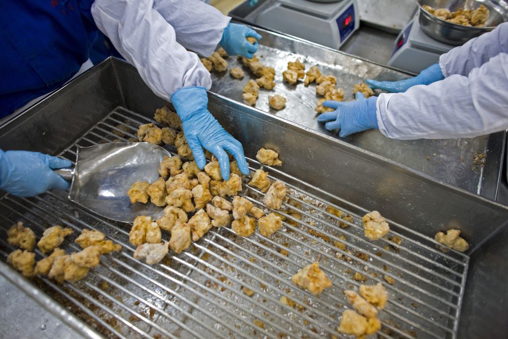 Staff work at a meat processing plant in Weifeng, Shandong province, China, on Sunday, Oct. 12, 2008.