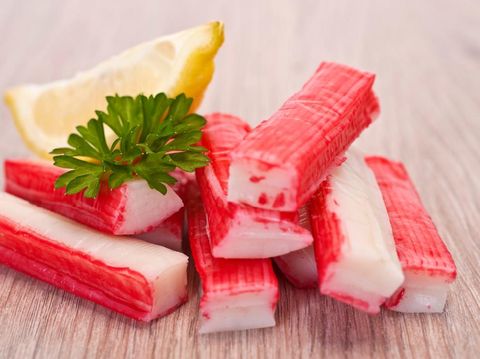 Salad crab sticks in a plate on a white table