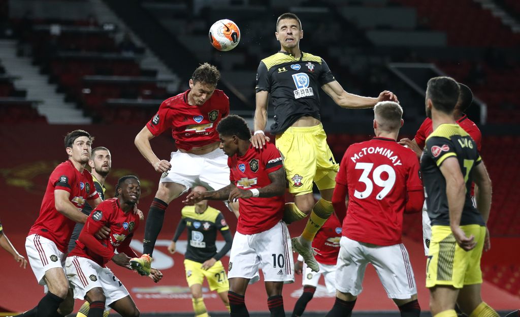 harry maguire manchester united vs southampton liga inggris premier league Southampton's Jan Bednarek heads the ball during the English Premier League soccer match between Manchester United and Southampton at Old Trafford in Manchester, England, Monday, July 13, 2020. (AP Photo/Clive Brunskill,Pool)