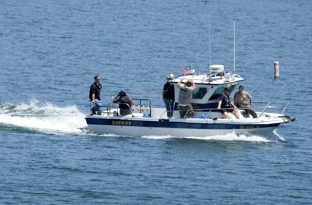 Naya Rivera's father, George Rivera, right, and mother Yolanda, left, with members of Ventura County Sheriff's Office are seen in a boat after Naya Rivera's body was found in Lake Piru, Monday, July 13, 2020, in Lake Piru, Calif. (AP Photo/Ringo H.W. Chiu)