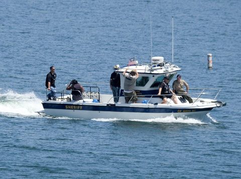 Naya Rivera's father, George Rivera, right, and mother Yolanda, left, with members of Ventura County Sheriff's Office are seen in a boat after Naya Rivera's body was found in Lake Piru, Monday, July 13, 2020, in Lake Piru, Calif. (AP Photo/Ringo H.W. Chiu)