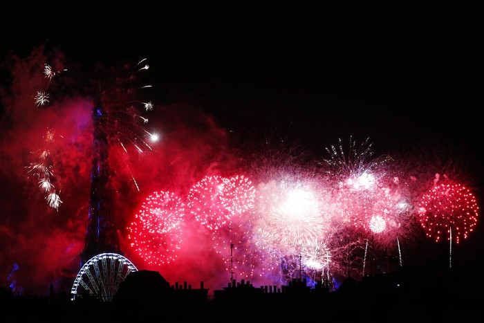 Fireworks illuminate the Paris' roofs during Bastille Day celebrations late Tuesday, July 14, 2020. (AP Photo/Thibault Camus)