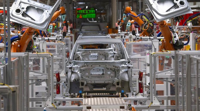 FILE- In this Tuesday, Feb. 25, 2020 file photo, workers complete an electric car ID.3 body at the assembly line during a press tour at the plant of the German manufacturer Volkswagen AG (VW) in Zwickau, Germany. The coronavirus has cancelled business plans all over the world but Europes push into electric cars isnt one of them. Sales of battery-powered and hybrid cars have held up despite a deeply painful recession, mainly thanks to the action of governments. (AP Photo/Jens Meyer, file)
