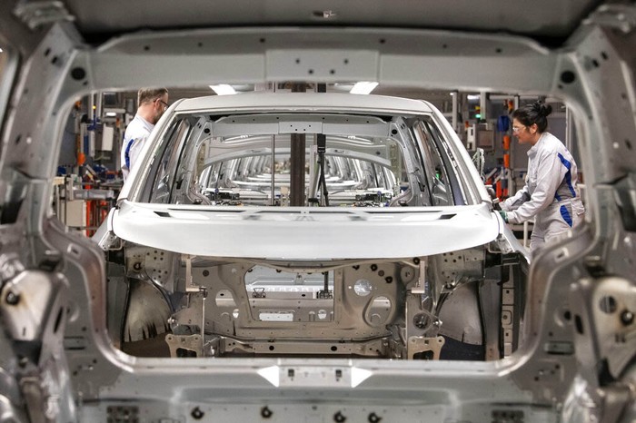 FILE- In this Tuesday, Feb. 25, 2020 file photo, workers complete an electric car ID.3 body at the assembly line during a press tour at the plant of the German manufacturer Volkswagen AG (VW) in Zwickau, Germany. The coronavirus has cancelled business plans all over the world but Europes push into electric cars isnt one of them. Sales of battery-powered and hybrid cars have held up despite a deeply painful recession, mainly thanks to the action of governments. (AP Photo/Jens Meyer, file)