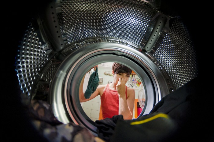 woman viewed from a washing machine with a funny grim