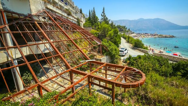 Kupari, Croatia- July 19, 2017 : The iron construction of an old ruined hotel Goricina in abandoned Yugoslavian military resort with a view of the beach on the Adriatic sea in Kupari, Croatia.