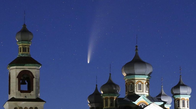 The comet Neowise or C/2020 F3 is seen behind an Orthodox church over the Turets, Belarus, 110 kilometers (69 miles) west of capital Minsk, early Tuesday, July 14, 2020. (AP Photo/Sergei Grits)