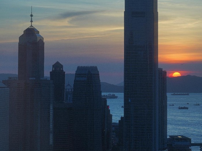 The skyline of the business district is silhouetted at sunset in Hong Kong Monday, July 13, 2020. (AP Photo/Vincent Yu)