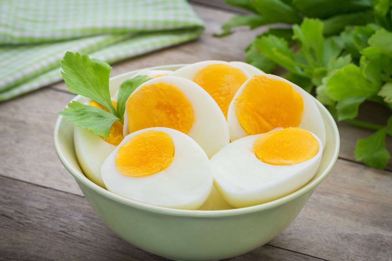 Pair of fried eggs in the shape of hearts on two pieces of toast on a plate