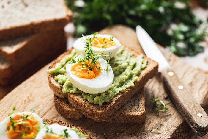 Pair of fried eggs in the shape of hearts on two pieces of toast on a plate