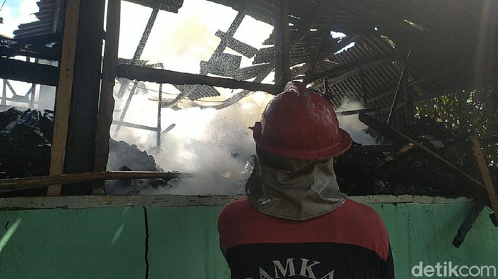 Petugas melakukan pemadaman terhadap bangunan yang terbakar