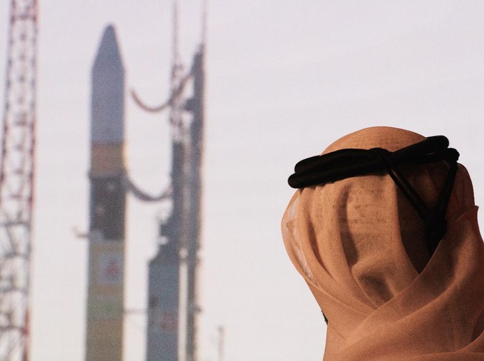 An Emirati man prepares to watch the launch of the 
