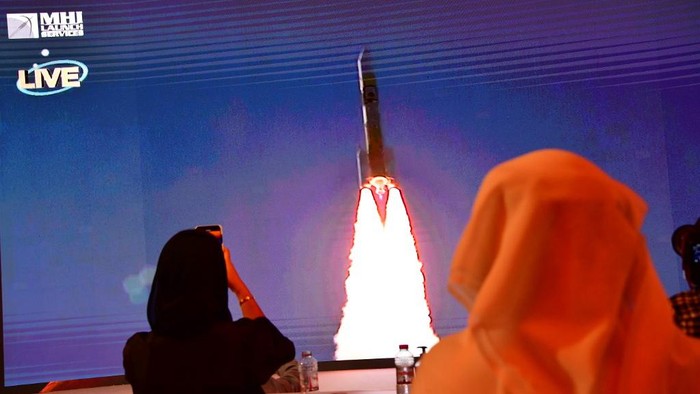 A picture taken on July 19, 2020, shows a screen broadcasting the launch of the 