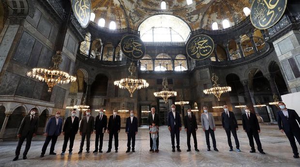 Turkey's President Recep Tayyip Erdogan, center, and other officials visit the Byzantine-era Hagia Sophia, one of Istanbul's main tourist attractions in the historic Sultanahmet district of Istanbul, Sunday, July 19, 2020, days after he formally reconverted Hagia Sophia into a mosque and declared it open for Muslim worship, after a high court annulled a 1934 decision that had made the religious landmark a museum.(Turkish Presidency via AP, Pool)