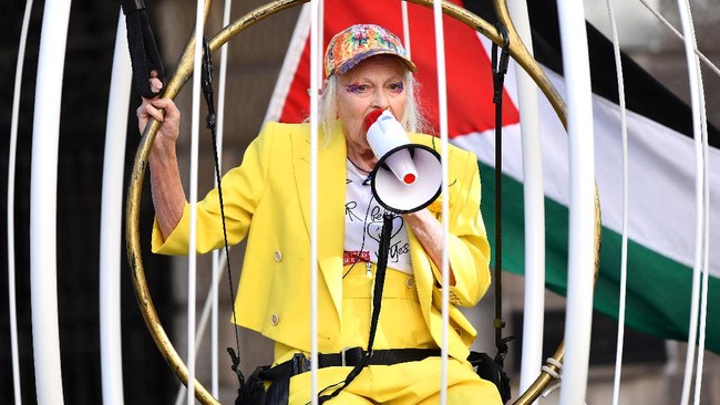 Dalam aksinya di depan Pengadilan Old Bailey, London, Westwood tampak mengenakan setelan berwarna kuning dan tampak duduk di ayunan yang berada di dalam sebuah sangkar raksasa. Dalam aksi tersebut, Westwood bersama sejumlah demonstran lainnya menolak ekstradisi pendiri WikiLeaks, Julian Assange ke Amerika Serikat. Getty Images/Gareth Cattermole.