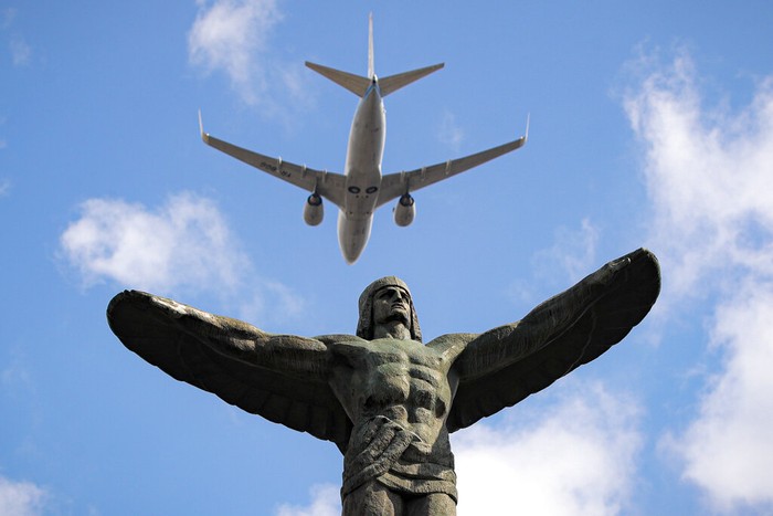 Planes fly above the Aviation Heroes' monument in Bucharest, Romania, Monday, July 20, 2020. A ceremony took place to mark Aviation Day next to the monument that celebrates aviators, both military and civilian, who lost their lives in the line of duty or contributed to the evolution of Romanian aviation. (AP Photo/Vadim Ghirda)