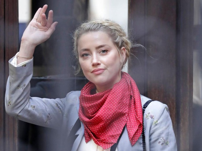 LONDON, ENGLAND - JULY 09: Amber Heard (red covering) is accompanied by her sister Whitney Heard (back L), her lawyer Jennifer Robinson (C), her personal assistant (R) and her girlfriend Bianca Butti (L) as she leaves the Royal Courts of Justice, Strand on July 9, 2020 in London, England. The Hollywood actor is taking News Group Newspapers, publishers of The Sun, to court over allegations that he was violent towards his ex-wife, Amber Heard, 34. (Photo by Chris J Ratcliffe/Getty Images )