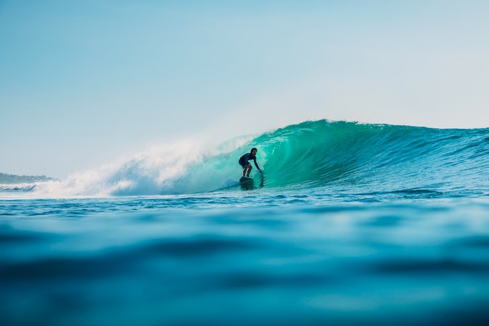 January 16, 2020. Bali, Indonesia. Surfer ride on ocean wave. Professional surfing in ocean at waves