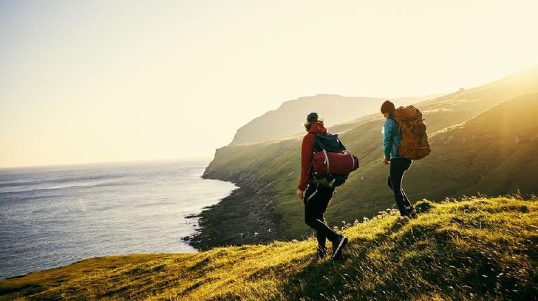 Shot of a young couple hiking through the mountains