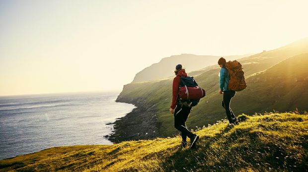 Shot of a young couple hiking through the mountains