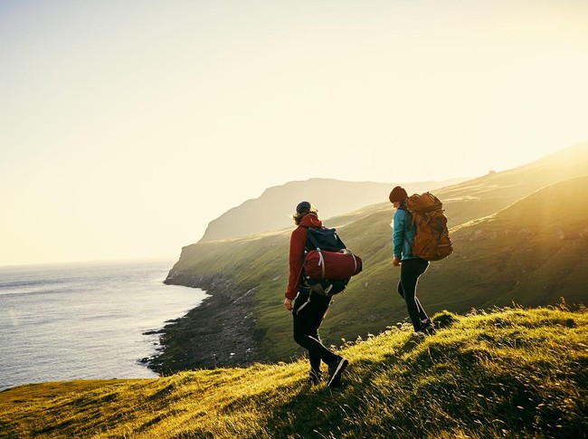 Shot of a young couple hiking through the mountains