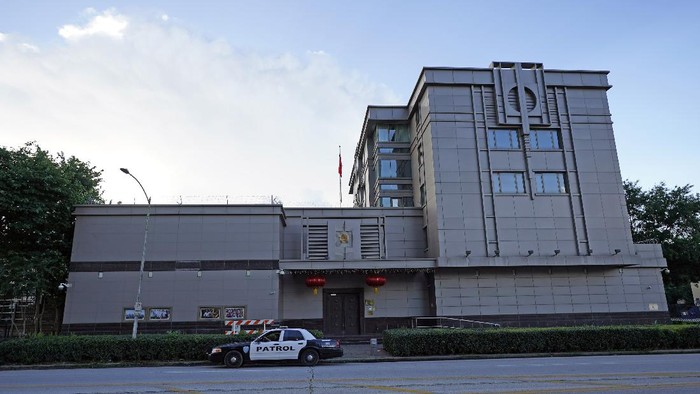 A security guard drives away from the Chinese Consulate General Wednesday, July 22, 2020, in Houston. Houston police and fire officials responded to reports that documents were being burned in the courtyard of the consulate Tuesday night, according to the Houston Police Department. China says the U.S. has ordered it to close its consulate in Houston in what it called a provocation that violates international law. (AP Photo/David J. Phillip)